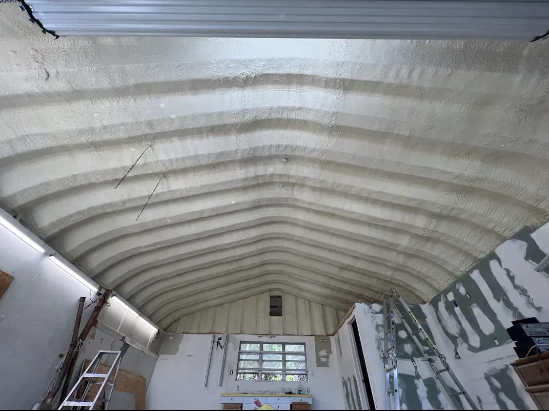 Spray polyurethane foam applied to the underside of a metal roof deck in Peru